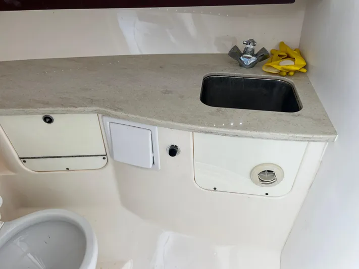  Yacht Photos Pics 2014 Everglades 350LX boat interior with sink and storage compartments.