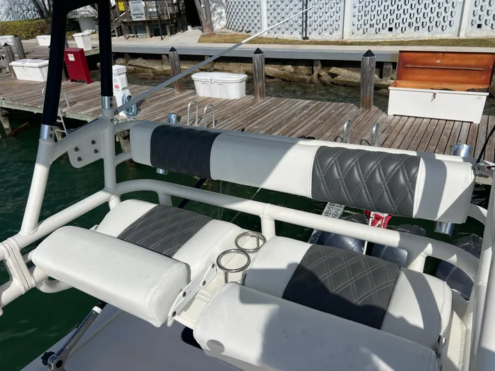  Yacht Photos Pics 2014 Everglades 350LX boat seating with quilted upholstery at a dock.