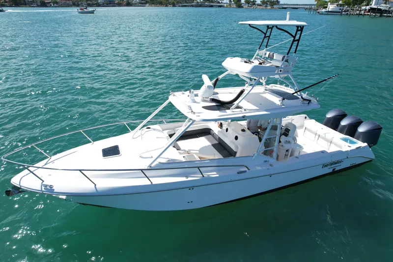  Yacht Photos Pics 2014 Everglades 350LX boat on clear blue water, featuring triple outboard engines.
