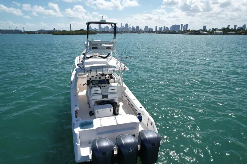  Yacht Photos Pics 2014 Everglades 350LX boat on water with city skyline in background.