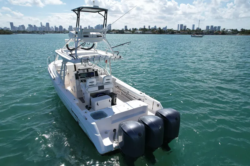  Yacht Photos Pics 2014 Everglades 350LX boat on water with city skyline in background.