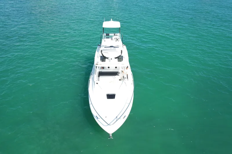  Yacht Photos Pics 2014 Everglades 350LX boat on clear turquoise water, aerial view.
