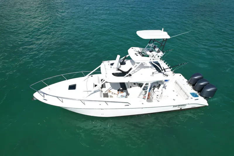  Yacht Photos Pics 2014 Everglades 350LX boat on clear blue water, featuring triple outboard engines.