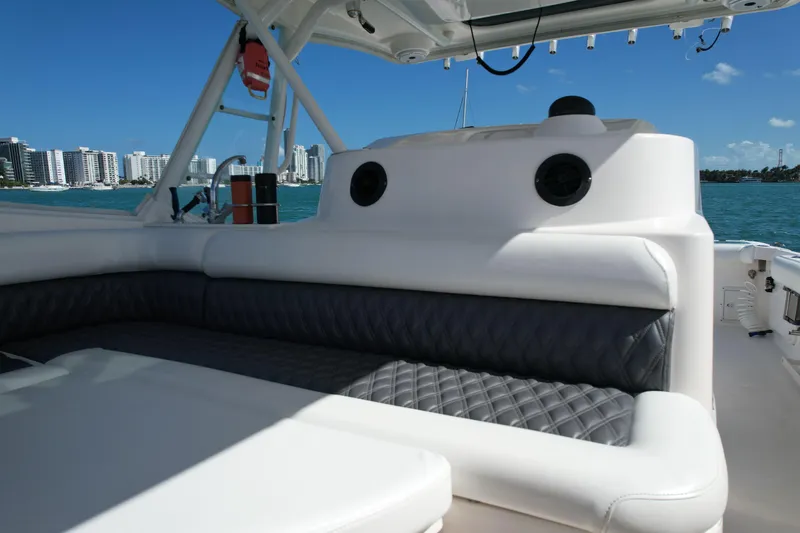  Yacht Photos Pics 2014 Everglades 350LX boat interior with cushioned seating, ocean view, and city skyline.
