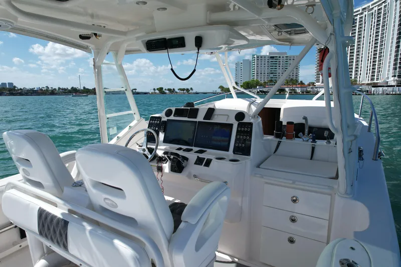  Yacht Photos Pics 2014 Everglades 350LX boat interior with modern controls, docked near waterfront buildings.