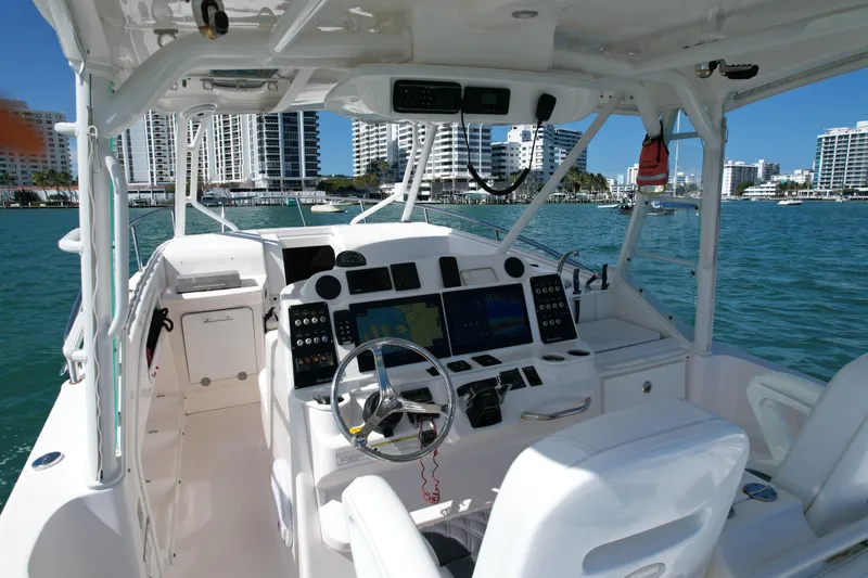  Yacht Photos Pics Interior view of 2014 Everglades 350LX boat with modern dashboard and waterfront cityscape.