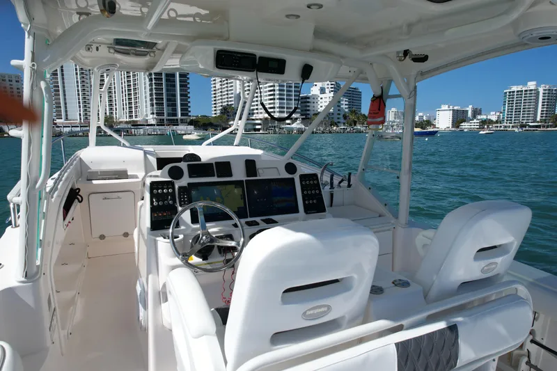  Yacht Photos Pics 2014 Everglades 350LX boat interior with modern controls, docked near city skyline.