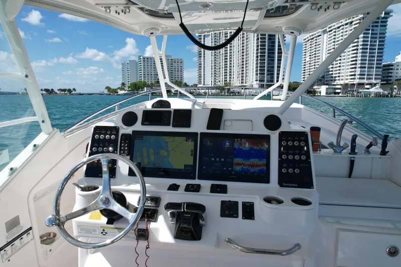  Yacht Photos Pics Cockpit view of 2014 Everglades 350LX boat with city skyline in background.