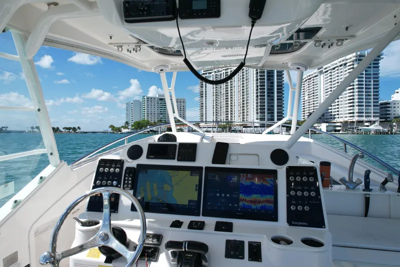  Yacht Photos Pics Cockpit view of 2014 Everglades 350LX boat with city skyline in background.