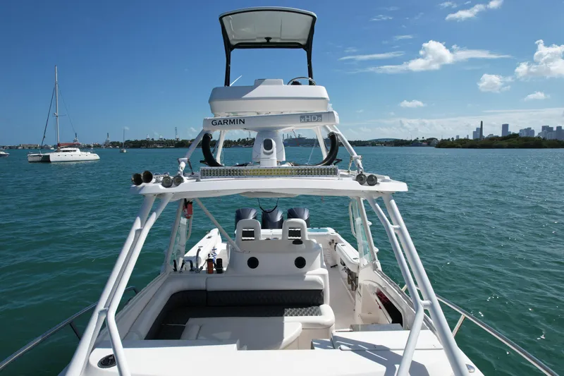  Yacht Photos Pics 2014 Everglades 350LX boat on water, featuring Garmin equipment, with city skyline in background.