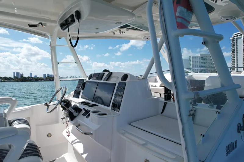 Yacht Photos Pics 2014 Everglades 350LX boat cockpit with modern controls, steering wheel, and ocean view.