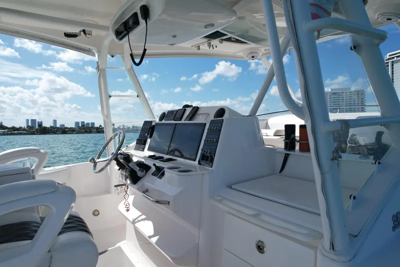  Yacht Photos Pics Interior view of 2014 Everglades 350LX boat cockpit with modern controls and ocean backdrop.