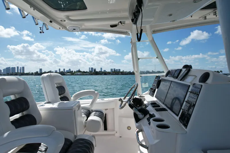  Yacht Photos Pics Interior view of 2014 Everglades 350LX boat with city skyline and ocean backdrop.