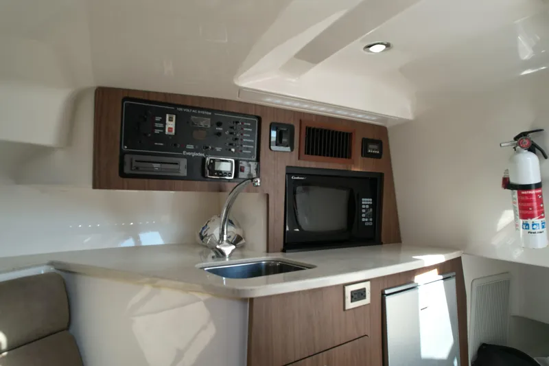  Yacht Photos Pics 2014 Everglades 350LX boat interior with kitchenette, microwave, and control panel.