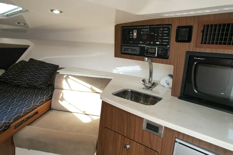  Yacht Photos Pics 2014 Everglades 350LX cabin interior with kitchenette, sink, and seating area.