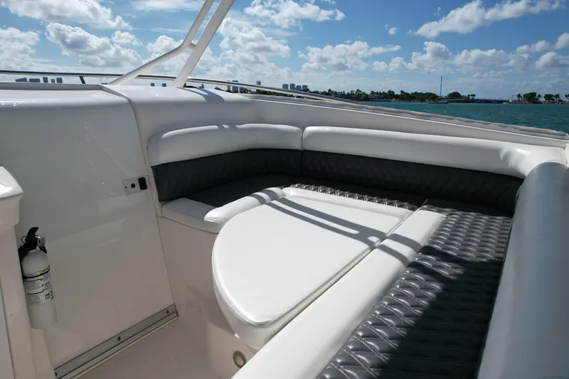  Yacht Photos Pics 2014 Everglades 350LX boat interior with cushioned seating, ocean view, and clear sky.