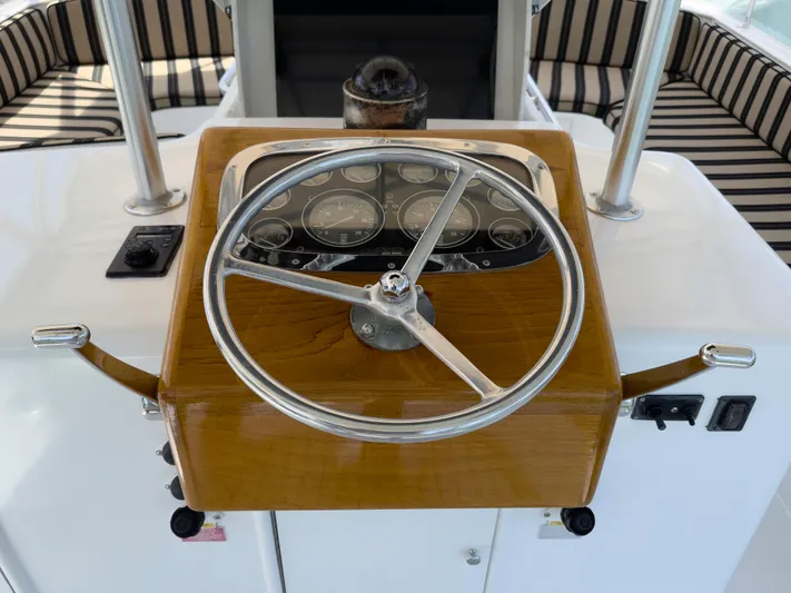 Vintage 1990 Yacht Photos Pics Steering console of a 1990 Buddy Davis 61 Convertible boat with wooden finish.