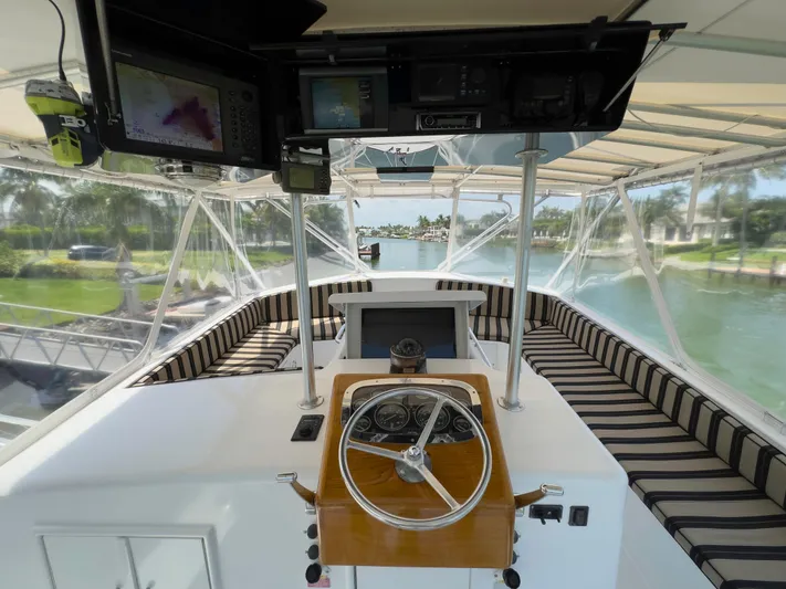 Vintage 1990 Yacht Photos Pics 1990 Buddy Davis 61 Convertible yacht helm with striped seating and navigation equipment.