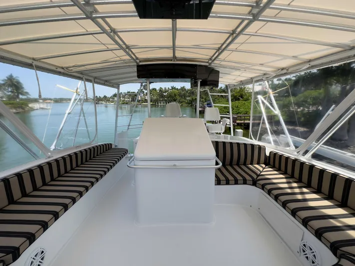 Vintage 1990 Yacht Photos Pics 1990 Buddy Davis 61 Convertible boat interior with striped seating and canopy.
