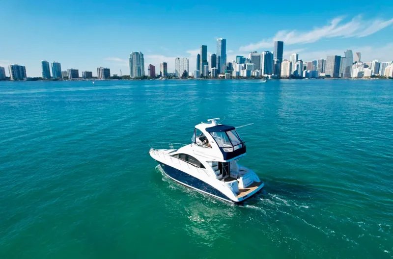  Yacht Photos Pics 2007 Sea Ray 360 Sedan Bridge yacht cruising near city skyline.