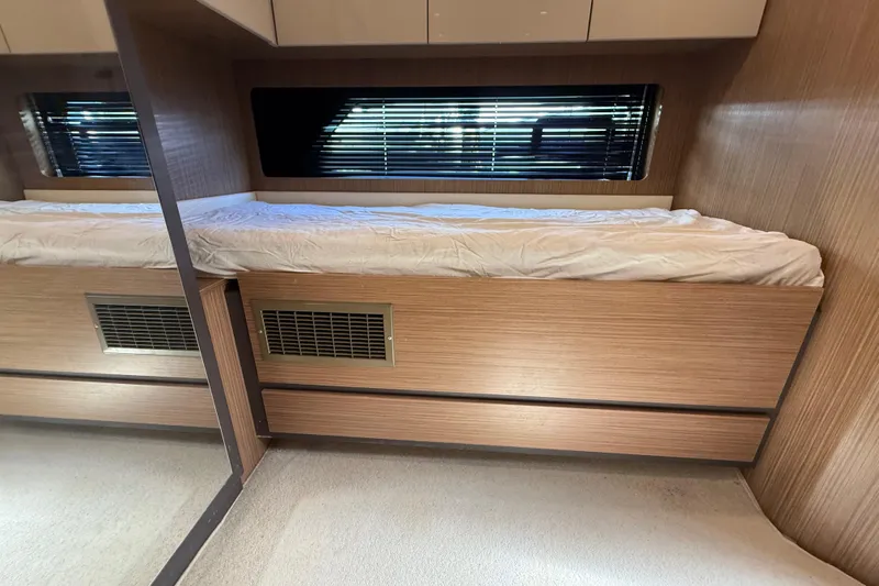  Yacht Photos Pics Interior cabin of 2016 Azimut Atlantis 43 yacht with wooden paneling and bed.