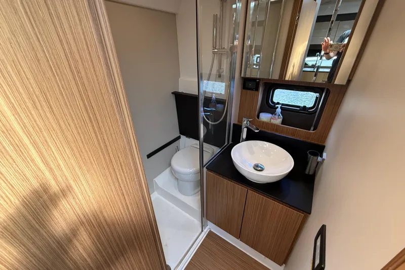  Yacht Photos Pics Luxurious bathroom in 2016 Azimut Atlantis 43 yacht with modern fixtures and wood accents.