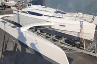 2019 Dragonfly 28 Performance trimaran on trailer, parked outdoors.