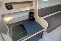 Compact kitchen area in 2019 Dragonfly 28 Performance sailboat with sink and coffee maker.
