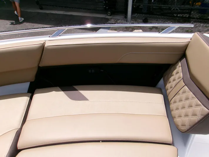  Yacht Photos Pics Luxurious seating on 2026 Monterey Elite 27 OB boat, featuring beige upholstery and quilted accents.