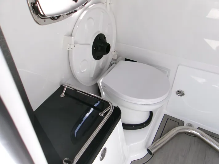  Yacht Photos Pics Interior of 2026 Monterey Elite 27 OB boat bathroom with toilet and sleek design.