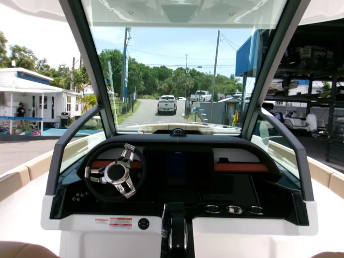  Yacht Photos Pics Interior view of 2026 Monterey Elite 27 OB boat dashboard with steering wheel and controls.