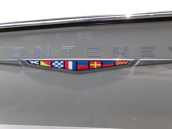  Yacht Photos Pics 2026 Monterey Elite 27 OB boat emblem with nautical flags.