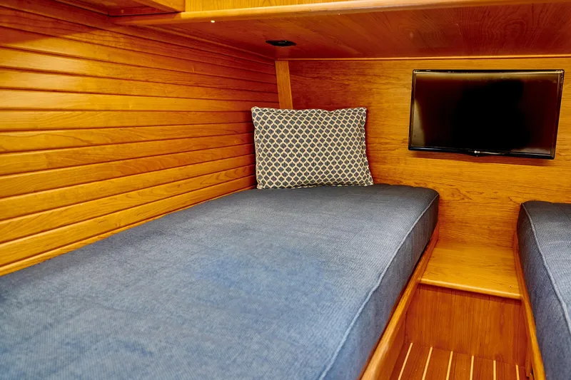 On Order, Ready For Customization Yacht Photos Pics Interior of 2027 Sabre 45 Salon Express with wood paneling and TV.