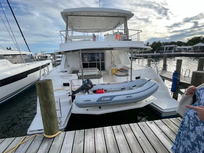 Nerdvana Yacht Photos Pics 2019 Leopard 51 Powercat docked with inflatable dinghy at marina.
