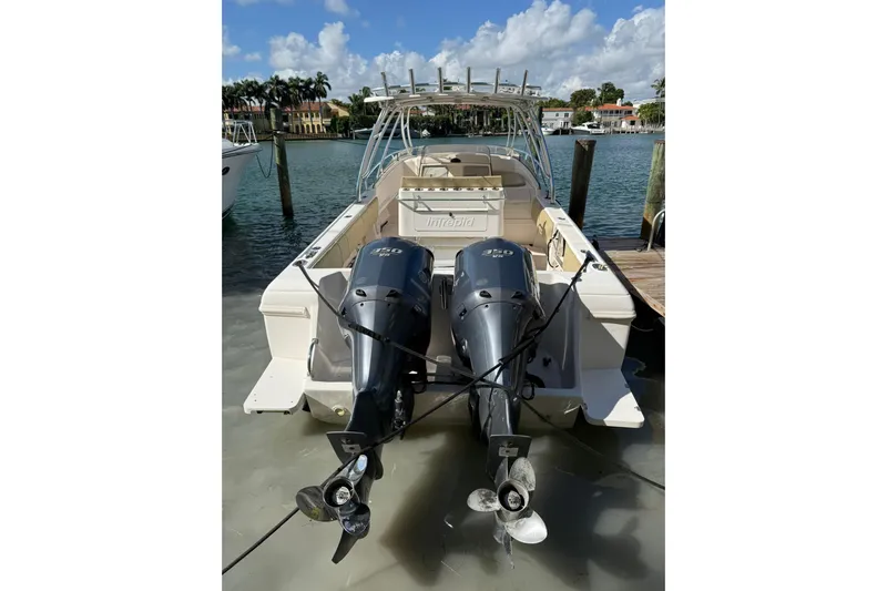  Yacht Photos Pics 2008 Intrepid 370 Cuddy boat with dual outboard engines docked by the water.