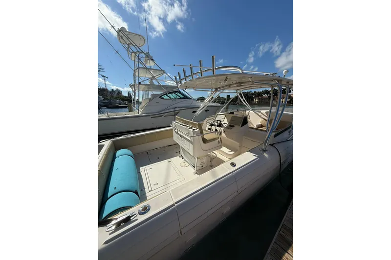  Yacht Photos Pics 2008 Intrepid 370 Cuddy boat docked, featuring spacious seating and helm under clear skies.