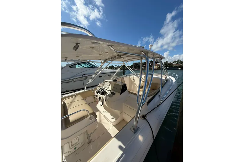  Yacht Photos Pics 2008 Intrepid 370 Cuddy boat with spacious cockpit and sleek design under blue sky.