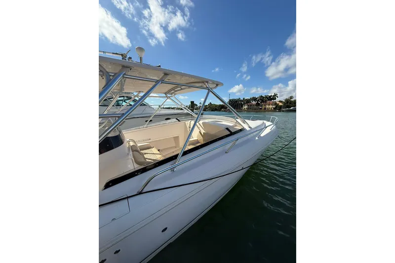  Yacht Photos Pics 2008 Intrepid 370 Cuddy boat on calm water under blue sky.