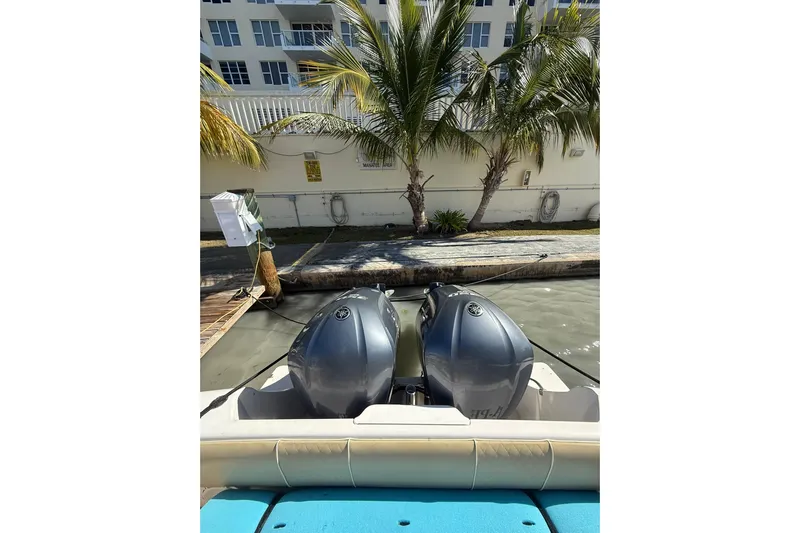  Yacht Photos Pics 2008 Intrepid 370 Cuddy with dual outboard engines docked near palm trees.