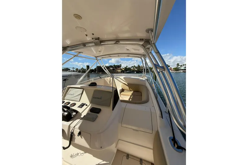  Yacht Photos Pics 2008 Intrepid 370 Cuddy boat interior with Garmin navigation, docked by waterfront homes.