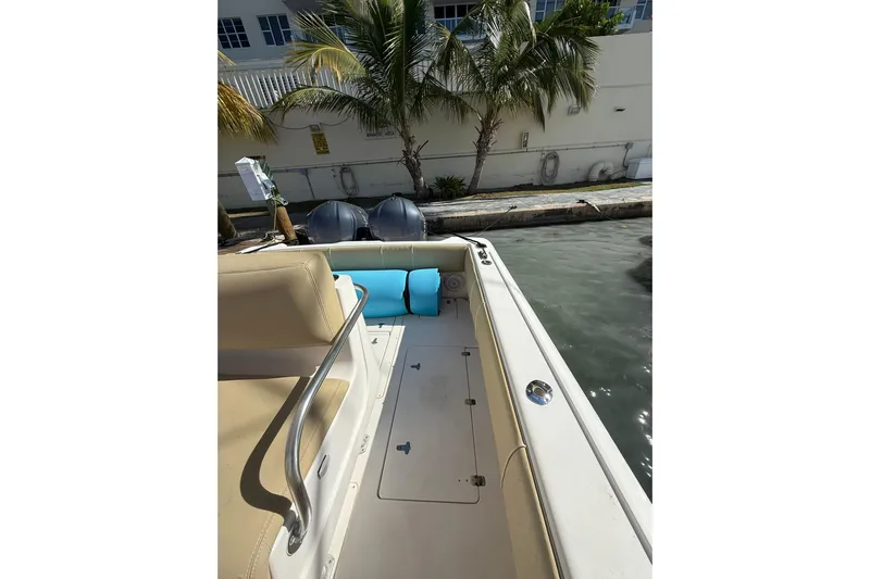  Yacht Photos Pics 2008 Intrepid 370 Cuddy boat interior with seating and railing, docked near palm trees.