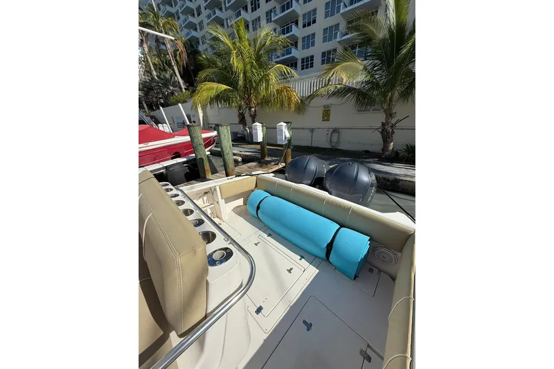  Yacht Photos Pics 2008 Intrepid 370 Cuddy boat docked, featuring seating and palm trees in the background.