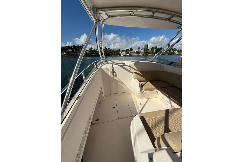  Yacht Photos Pics 2008 Intrepid 370 Cuddy boat interior with seating, under a clear blue sky.
