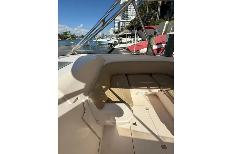  Yacht Photos Pics 2008 Intrepid 370 Cuddy boat interior with seating, docked by waterfront.