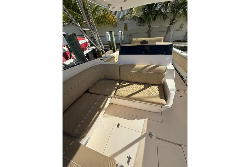  Yacht Photos Pics 2008 Intrepid 370 Cuddy boat interior with beige seating and palm trees in the background.