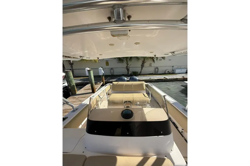  Yacht Photos Pics 2008 Intrepid 370 Cuddy boat interior with seating and helm, docked by the water.