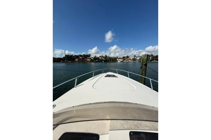 Yacht Photos Pics 2008 Intrepid 370 Cuddy boat on calm water with clear blue sky.