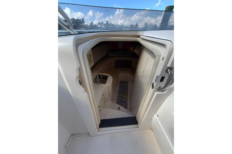  Yacht Photos Pics 2008 Intrepid 370 Cuddy cabin interior with open door, showcasing seating and storage.