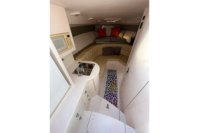  Yacht Photos Pics 2008 Intrepid 370 Cuddy interior with kitchenette, seating, and colorful rug.