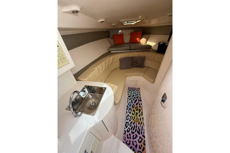  Yacht Photos Pics 2008 Intrepid 370 Cuddy interior with sink, seating, and colorful rug.